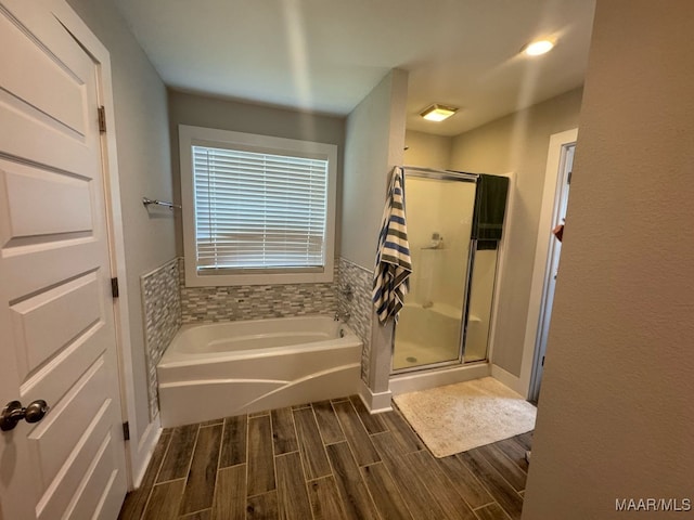 107 Jules Ln, Ashford, AL 36312 - full bathroom with a shower stall, wood finish floors, a garden tub, and baseboards