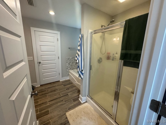 107 Jules Ln, Ashford, AL 36312 - full bath with wood finished floors, a shower stall, recessed lighting, baseboards, and a garden tub