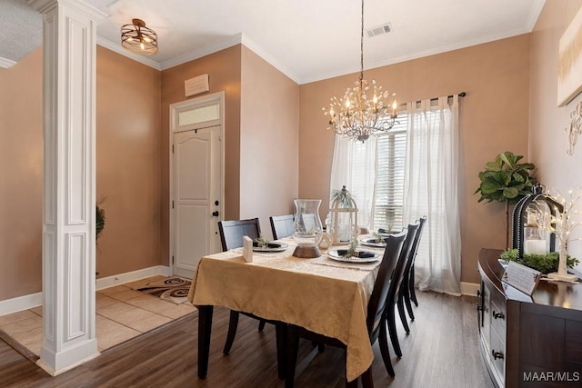 177 Old Orchard Loop, Deatsville, AL 36022 - dining room featuring wood finished floors, baseboards, a chandelier, ornate columns, and ornamental molding