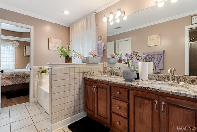 177 Old Orchard Loop, Deatsville, AL 36022 - ensuite bathroom featuring tile walls, tile patterned floors, double vanity, ornamental molding, and a wainscoted wall