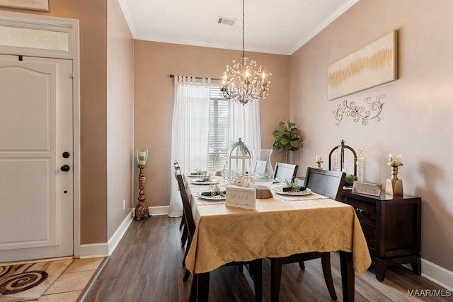 177 Old Orchard Loop, Deatsville, AL 36022 - dining room with a chandelier, crown molding, baseboards, and light wood-type flooring