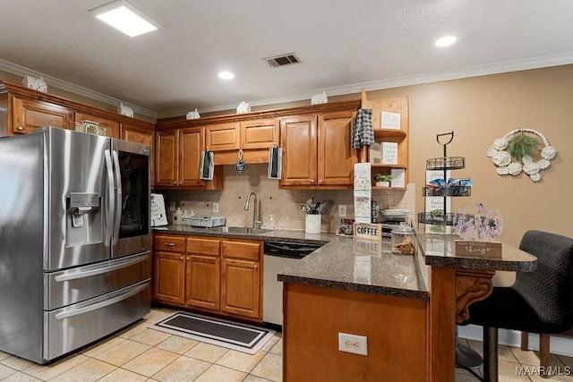 177 Old Orchard Loop, Deatsville, AL 36022 - kitchen featuring stainless steel fridge with ice dispenser, dishwashing machine, a peninsula, a kitchen breakfast bar, and brown cabinets