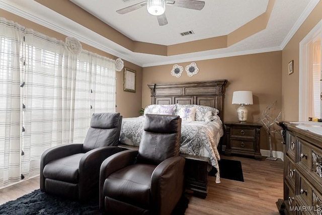 177 Old Orchard Loop, Deatsville, AL 36022 - bedroom featuring a raised ceiling, light wood-style floors, a ceiling fan, and ornamental molding