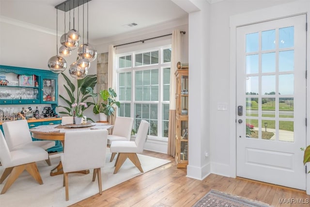8307 Young Xing, Montgomery, AL 36116 - dining space featuring crown molding, visible vents, an inviting chandelier, and light wood finished floors