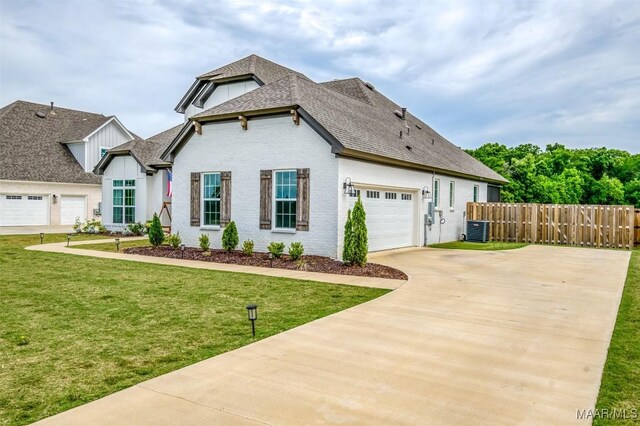 8307 Young Xing, Montgomery, AL 36116 - french country home with driveway, roof with shingles, central AC unit, brick siding, and fence