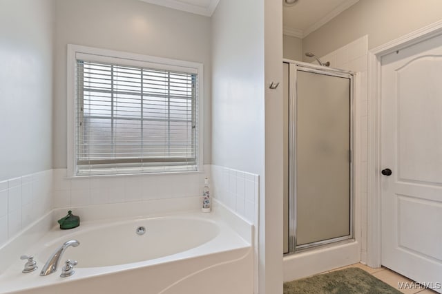 bathroom featuring a garden tub, crown molding, and a shower stall