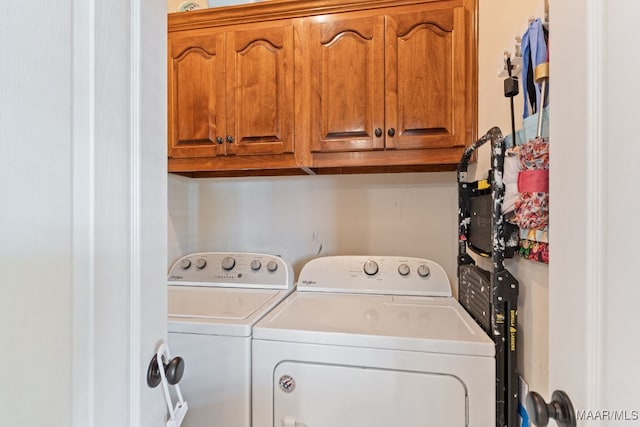 laundry room with cabinet space and independent washer and dryer