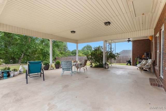 view of patio with a ceiling fan, outdoor dining area, and a fenced backyard