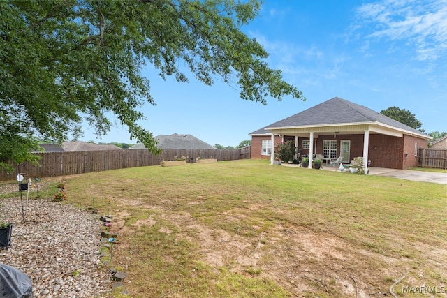 view of yard with a fenced backyard and a patio area