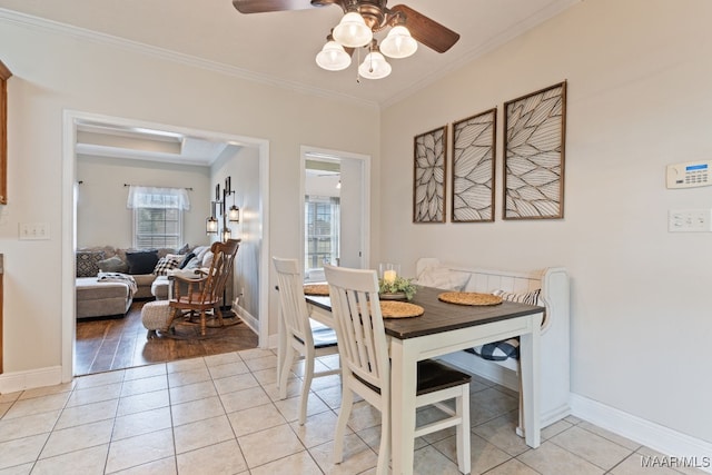 dining area featuring light tile patterned floors, ceiling fan, ornamental molding, and a wealth of natural light