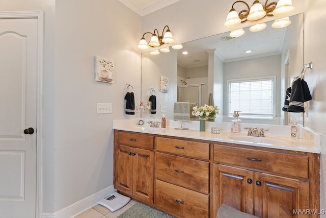 bathroom with double vanity, crown molding, tile patterned flooring, a sink, and baseboards