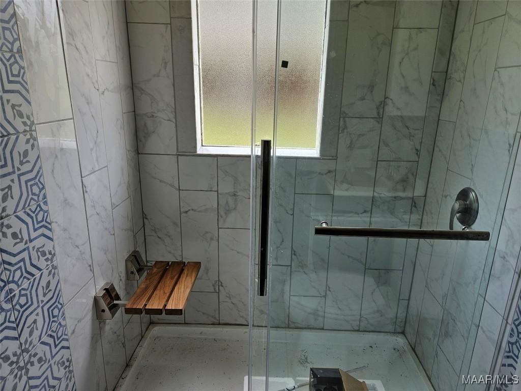 full bathroom featuring a stall shower