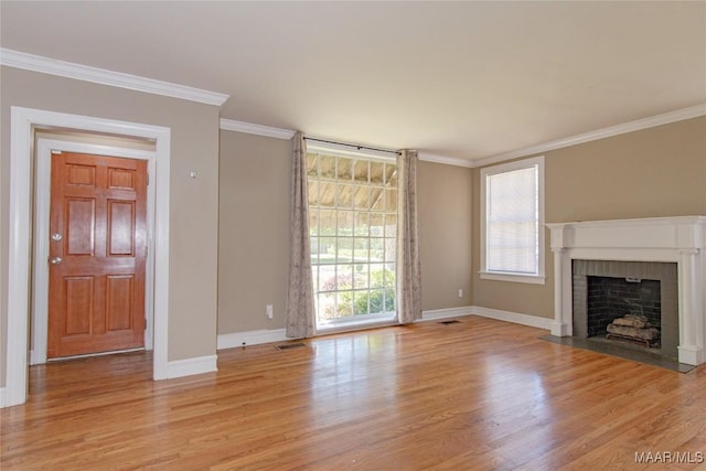 1943 Gorgas St, Montgomery, AL 36106 - unfurnished living room with crown molding, baseboards, a fireplace, and light wood finished floors