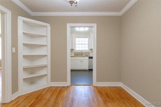 1943 Gorgas St, Montgomery, AL 36106 - hall featuring a sink, crown molding, light wood finished floors, and built in shelves