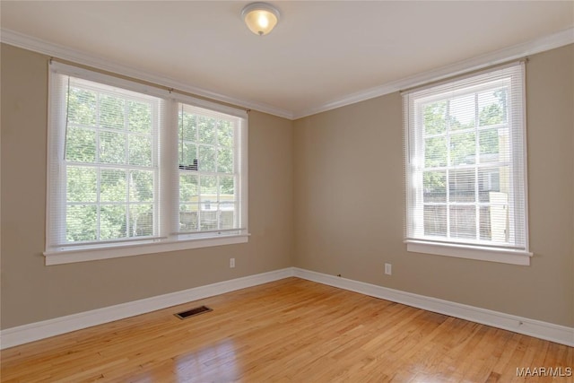 1943 Gorgas St, Montgomery, AL 36106 - unfurnished room featuring visible vents, ornamental molding, light wood-style flooring, and a wealth of natural light