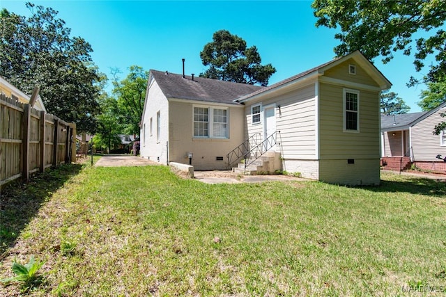 1943 Gorgas St, Montgomery, AL 36106 - back of property featuring a lawn, fence, and crawl space