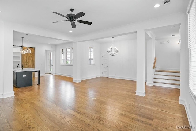 4831 Clerkenwell St, Montgomery, AL 36116 - unfurnished living room with stairs, baseboards, ceiling fan with notable chandelier, light wood-style floors, and recessed lighting