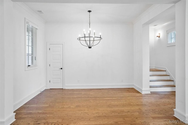 4831 Clerkenwell St, Montgomery, AL 36116 - unfurnished dining area with visible vents, wood finished floors, baseboards, stairway, and a chandelier