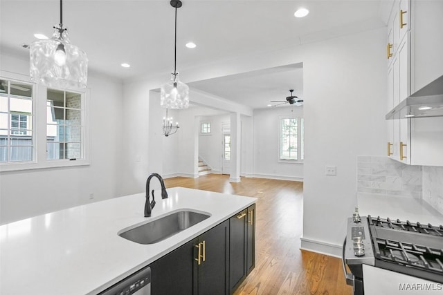 4831 Clerkenwell St, Montgomery, AL 36116 - kitchen featuring dark cabinets, a sink, gas range, and light countertops