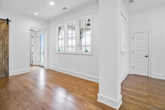 4831 Clerkenwell St, Montgomery, AL 36116 - entrance foyer featuring visible vents, wood finished floors, baseboards, recessed lighting, and a barn door