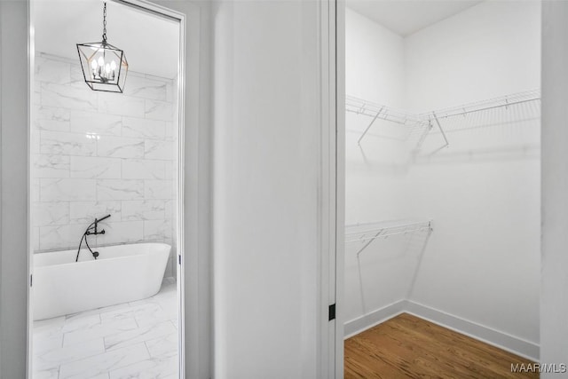 4831 Clerkenwell St, Montgomery, AL 36116 - bathroom with a freestanding tub, a walk in closet, marble finish floor, and a chandelier