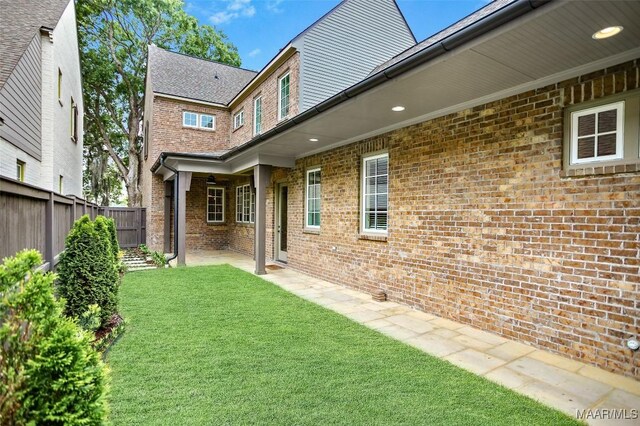 4831 Clerkenwell St, Montgomery, AL 36116 - exterior space with brick siding, a lawn, fence, and a patio
