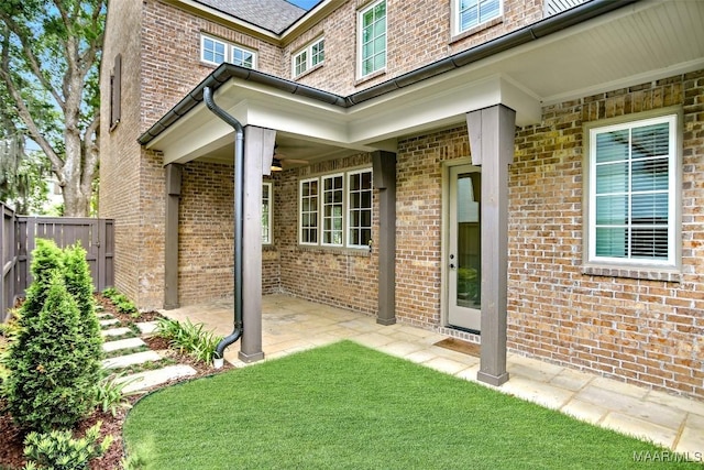 4831 Clerkenwell St, Montgomery, AL 36116 - view of exterior entry with fence, a patio, and brick siding