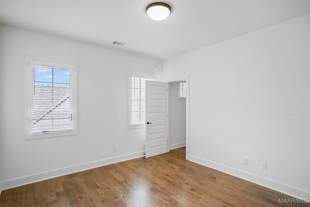 4831 Clerkenwell St, Montgomery, AL 36116 - empty room with visible vents, baseboards, wood finished floors, and a healthy amount of sunlight