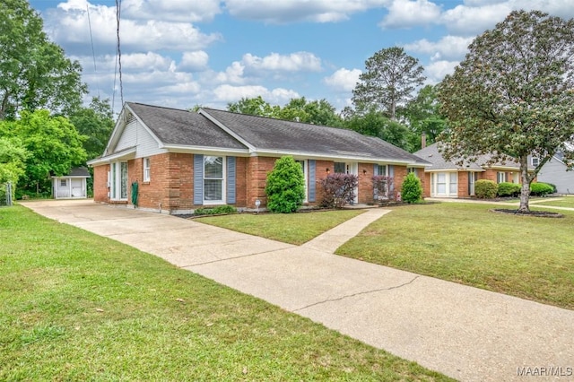ranch-style house with driveway, roof with shingles, brick siding, an outdoor structure, and a front lawn