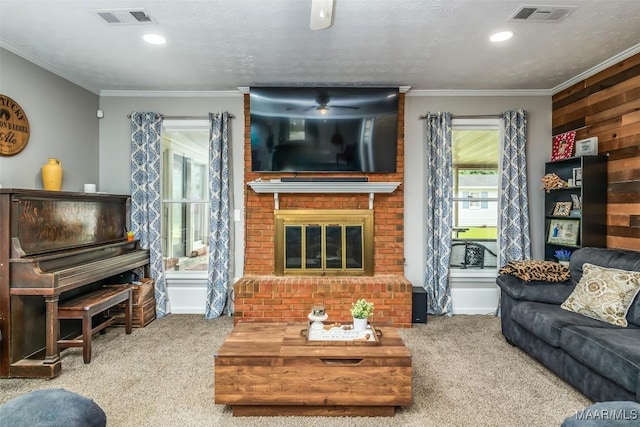 carpeted living area featuring ornamental molding, a fireplace, and visible vents