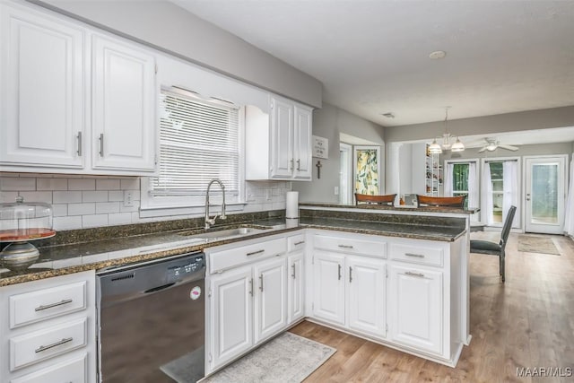 kitchen with white cabinets, a wealth of natural light, a sink, and dishwashing machine