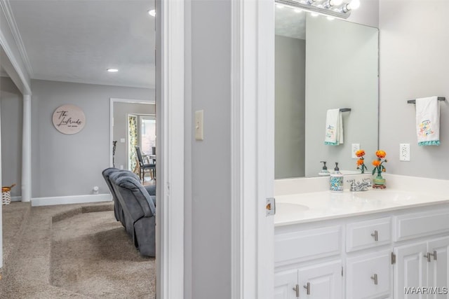 bathroom featuring double vanity, baseboards, recessed lighting, and a sink