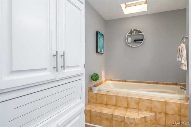 full bath featuring a skylight and a bath