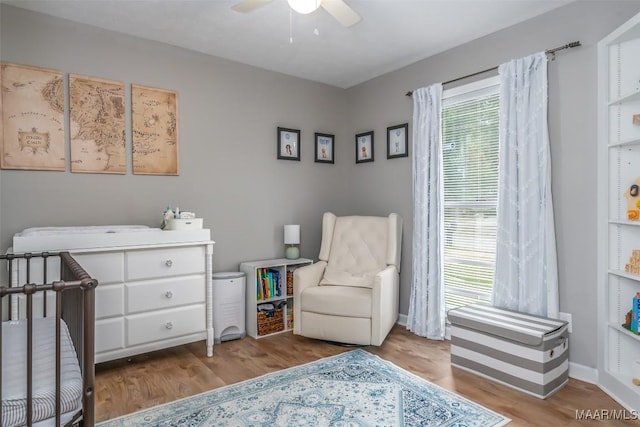 bedroom featuring baseboards, ceiling fan, and wood finished floors
