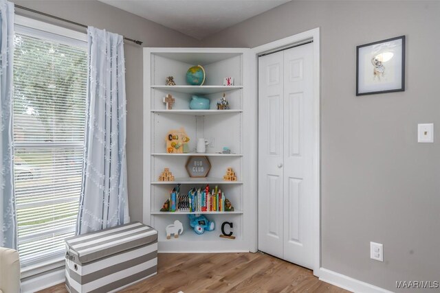 interior space featuring baseboards and wood finished floors