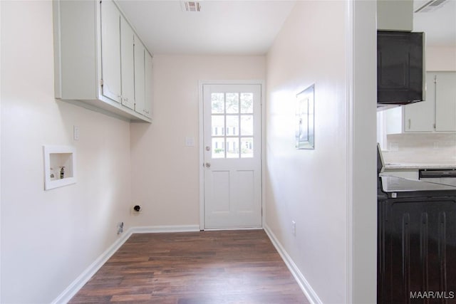 laundry area featuring electric panel, dark wood-style flooring, cabinet space, baseboards, and hookup for a washing machine