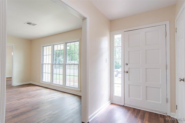entryway with baseboards, visible vents, plenty of natural light, and wood finished floors