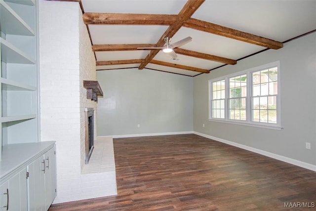 unfurnished living room with a brick fireplace, ceiling fan, vaulted ceiling with beams, and dark wood-type flooring