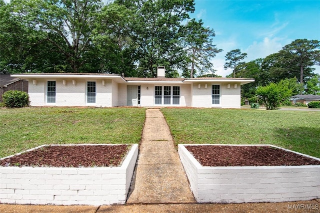 single story home with a chimney, a garden, and a front yard