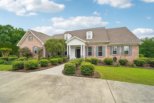 1750 County Road 461, Clanton, AL 35046 - view of front of home featuring brick siding, a front lawn, and a shingled roof