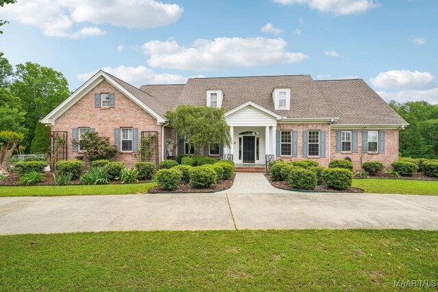 1750 County Road 461, Clanton, AL 35046 - view of front facade with brick siding, a front lawn, a porch, and roof with shingles