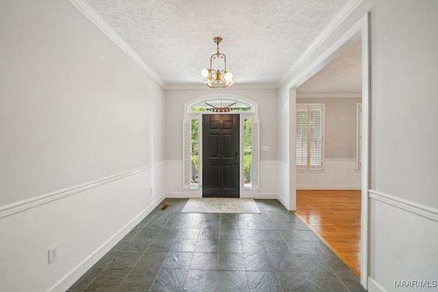 1750 County Road 461, Clanton, AL 35046 - foyer with a chandelier, a textured ceiling, ornamental molding, and wainscoting