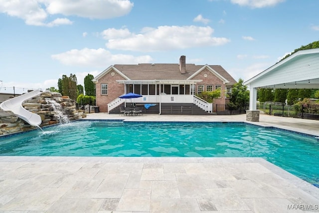1750 County Road 461, Clanton, AL 35046 - view of pool with stairway, a sunroom, a water slide, and a patio area