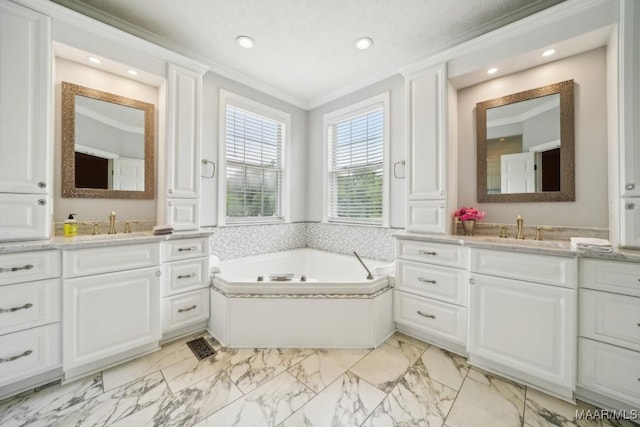 1750 County Road 461, Clanton, AL 35046 - bathroom with ornamental molding, two vanities, a bath, marble finish flooring, and recessed lighting