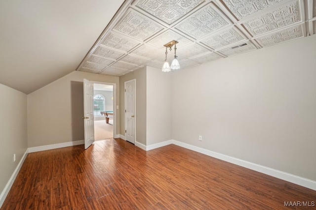1750 County Road 461, Clanton, AL 35046 - unfurnished room with wood finished floors, lofted ceiling, and a chandelier