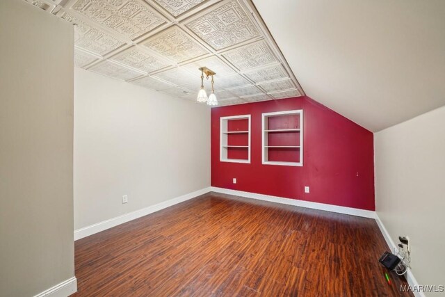 1750 County Road 461, Clanton, AL 35046 - additional living space with built in shelves, wood finished floors, and lofted ceiling