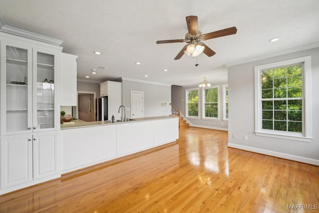 1750 County Road 461, Clanton, AL 35046 - unfurnished living room with crown molding, light wood-style floors, a ceiling fan, recessed lighting, and a chandelier