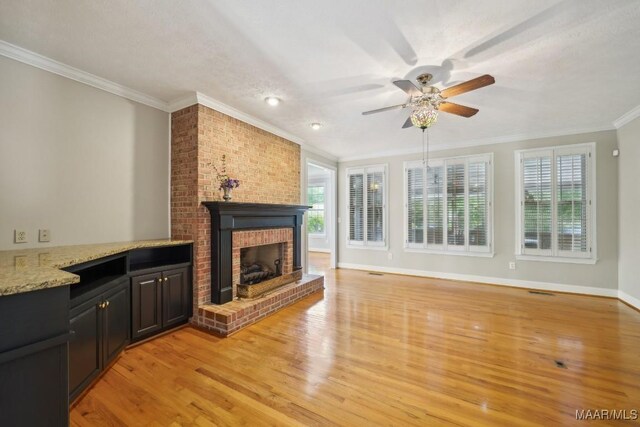 1750 County Road 461, Clanton, AL 35046 - unfurnished living room featuring ornamental molding, a ceiling fan, a fireplace, light wood-style flooring, and recessed lighting