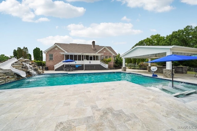 1750 County Road 461, Clanton, AL 35046 - view of pool featuring stairway, a water slide, a patio area, and a sunroom