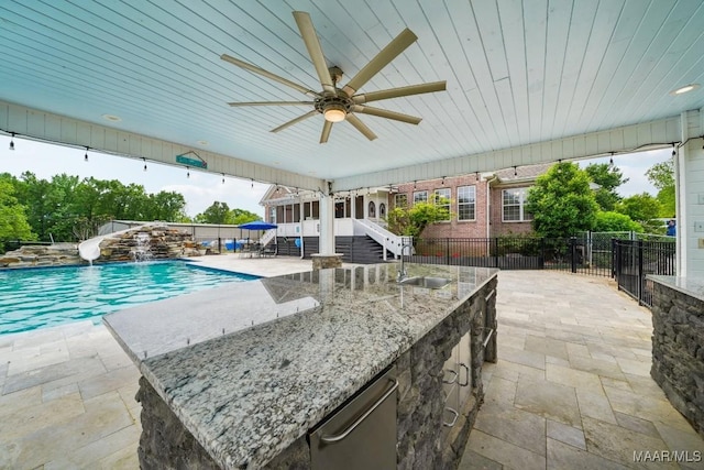 1750 County Road 461, Clanton, AL 35046 - view of pool featuring a patio, a water slide, a fenced backyard, exterior bar, and a ceiling fan